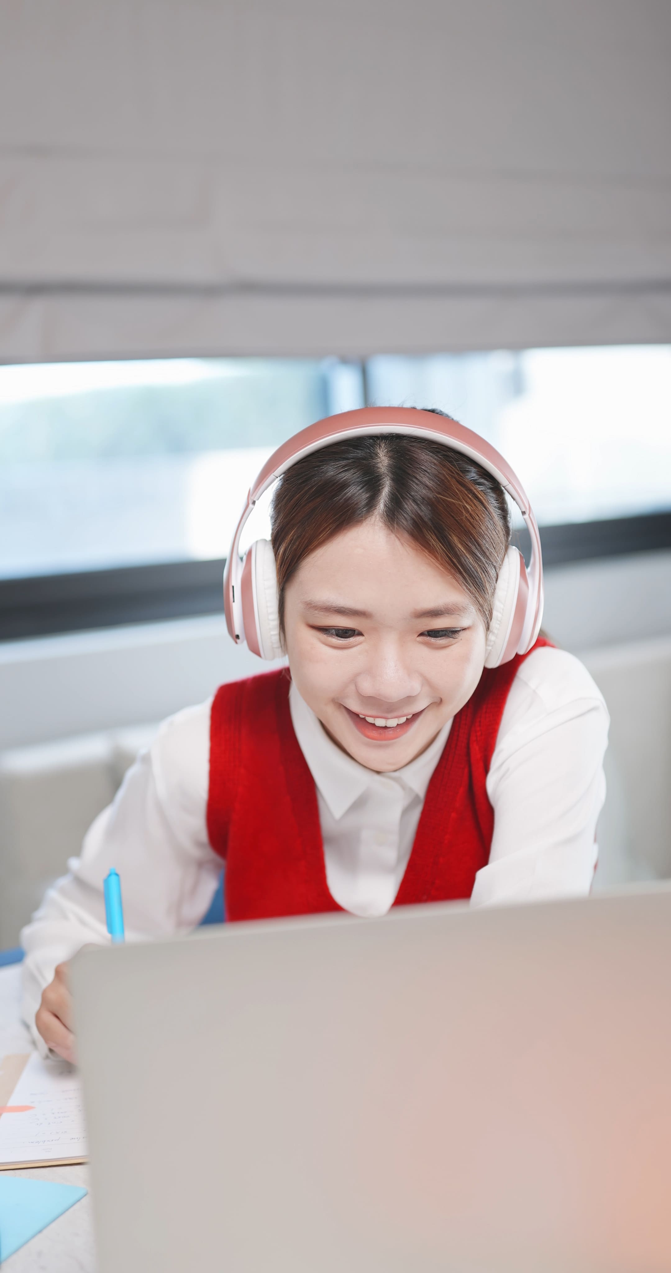 Smiling educator speaking with colleagues in a school setting