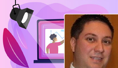 A purple laptop showing a video of a person explaining a graph on a whiteboard, on a pink and purple background with a spotlight.