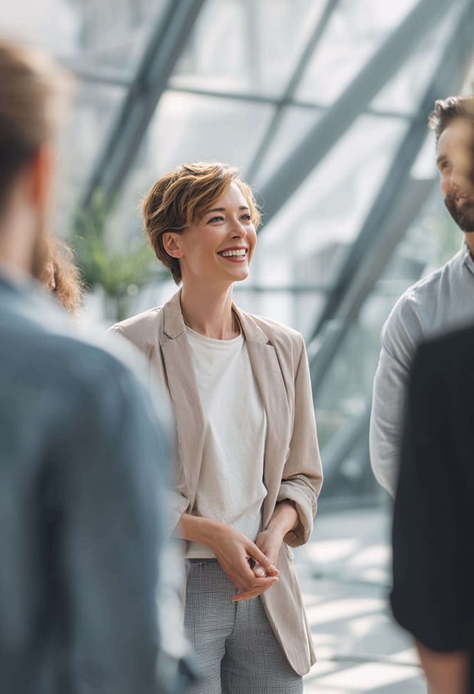 Smiling educator speaking with colleagues in a school setting