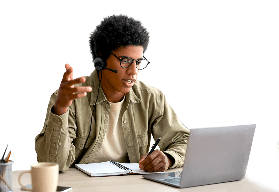 A young man using headset mic to talk into laptop